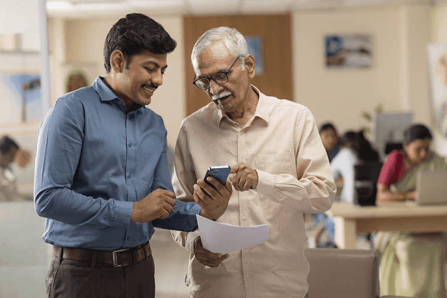 Two men looking at a smartphone together